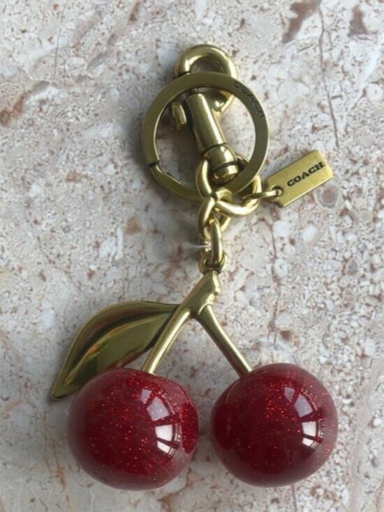 Coach Accessories - COACH Gold-Tone Keychain with Red Glitter Cherry Charm